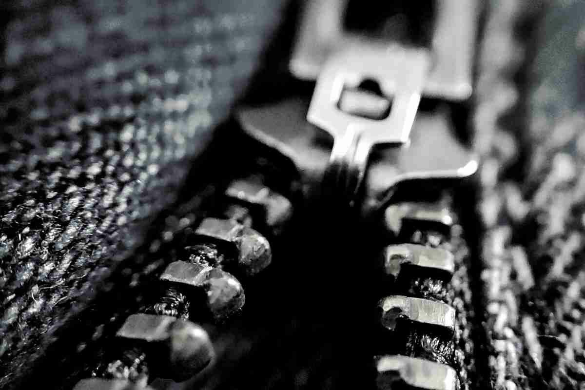 Studio Photography Of A Long Zipper Half Closed, In Light Back